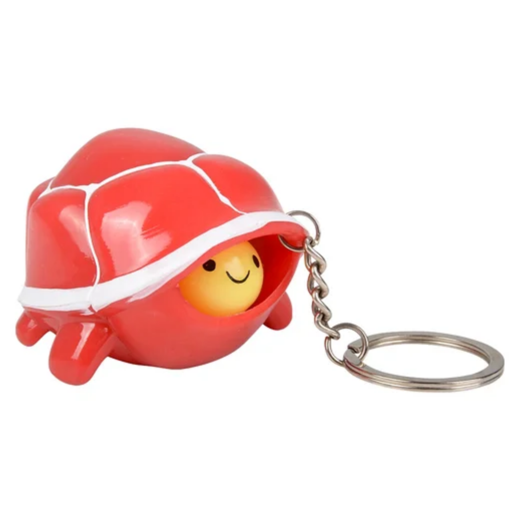 Keychain with a red shell and yellow face on a white background