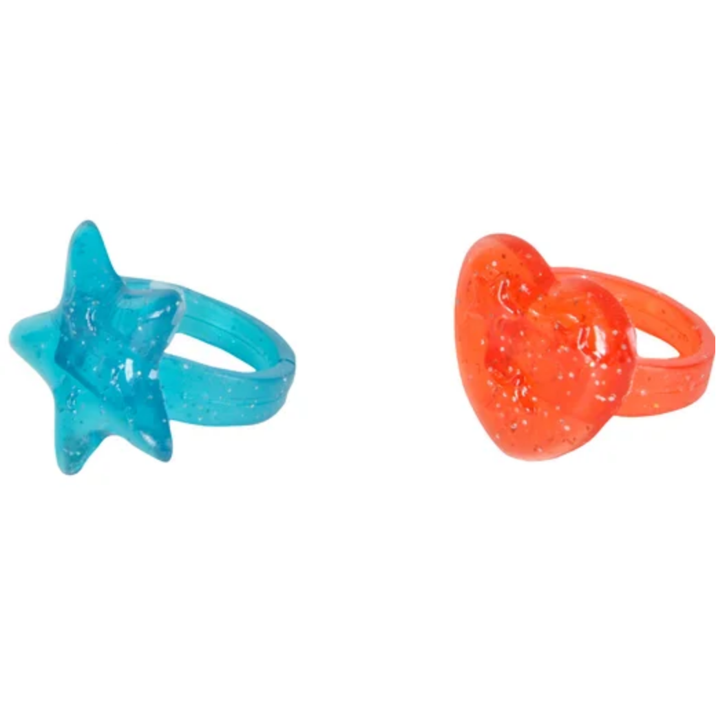 Two novelty rings, one blue star-shaped and one orange pacifier-shaped, on a white background 