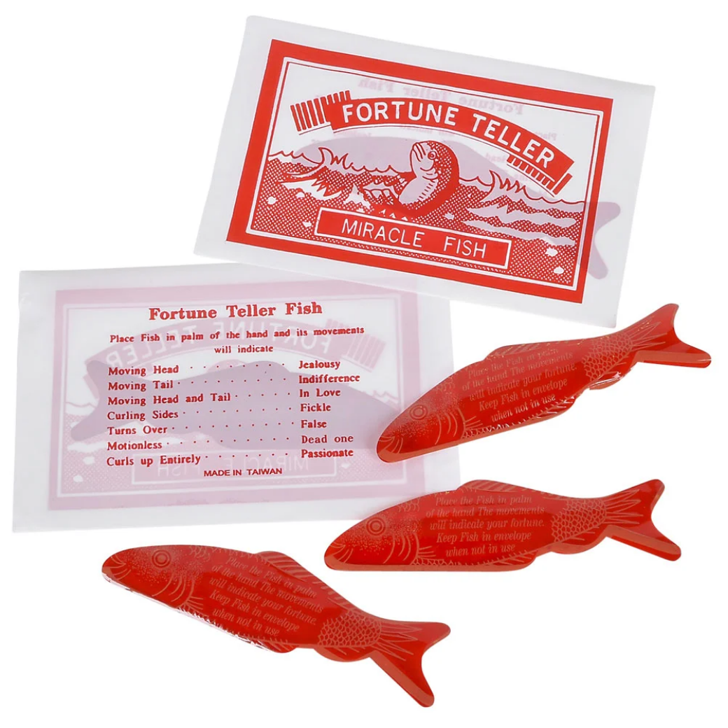 Red fortune telling fish with packaging and instructions on a white background