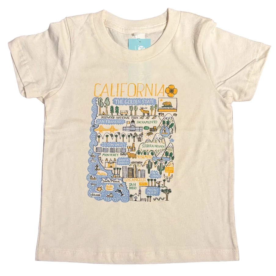 White t-shirt with colorful graphic design on a wooden surface