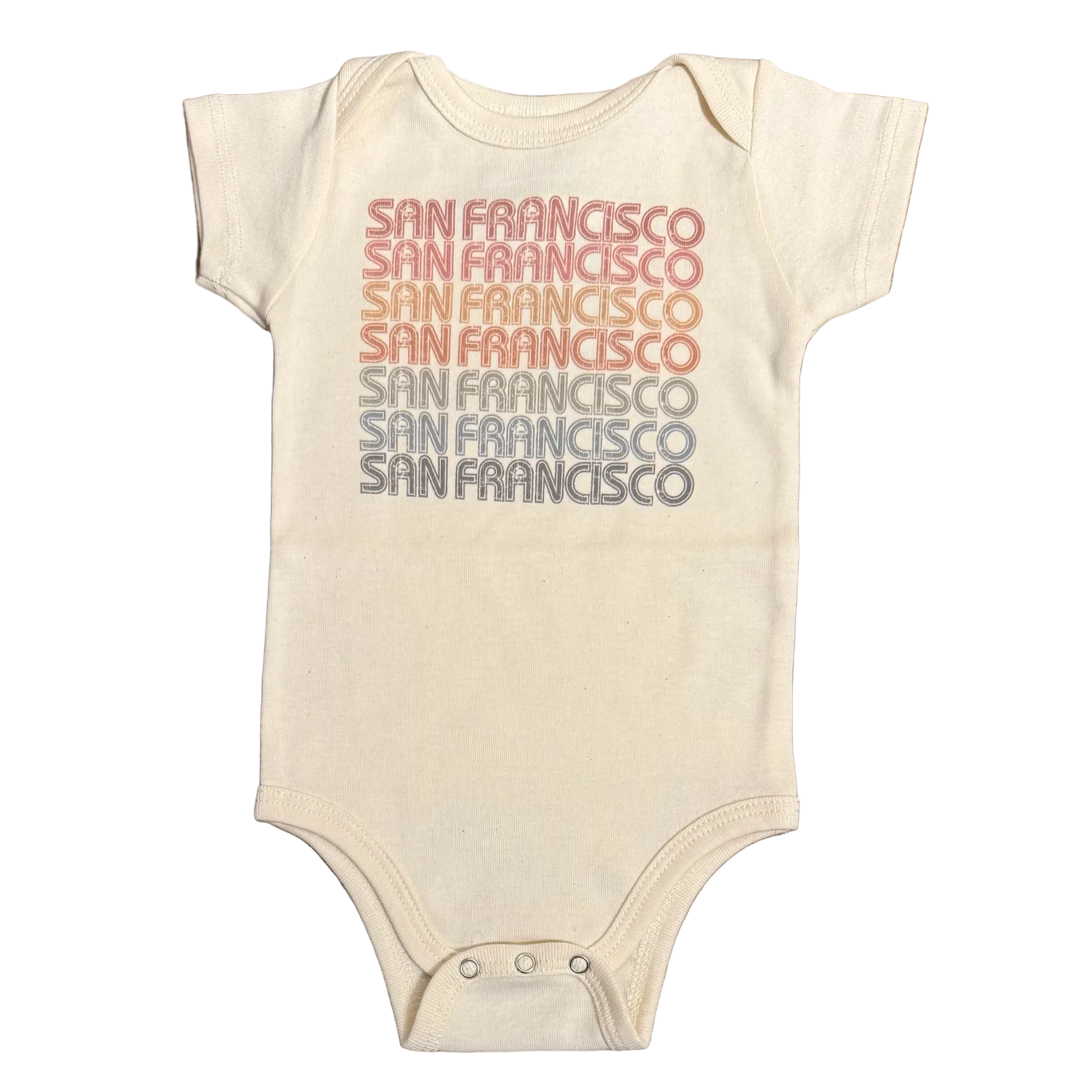 Beige baby onesie with 'San Francisco' printed in various colors on a wooden surface