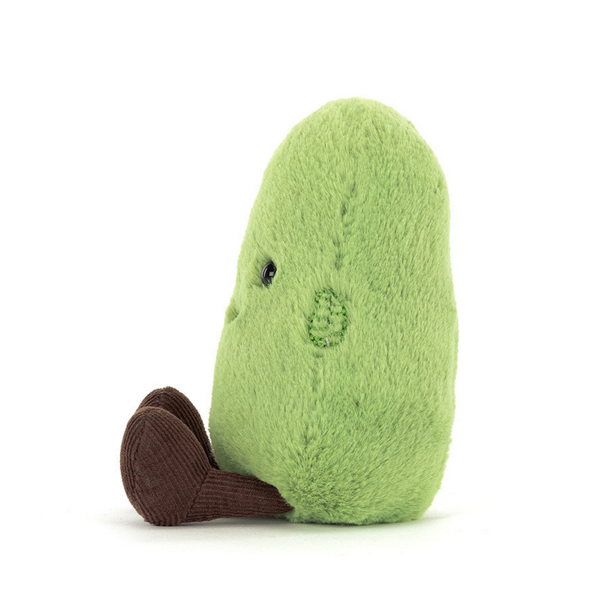Stuffed avocado toy on a white background