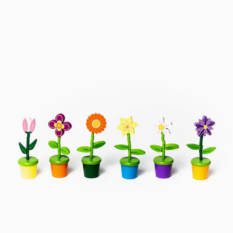 Set of colorful toy flowers in pots on a white background