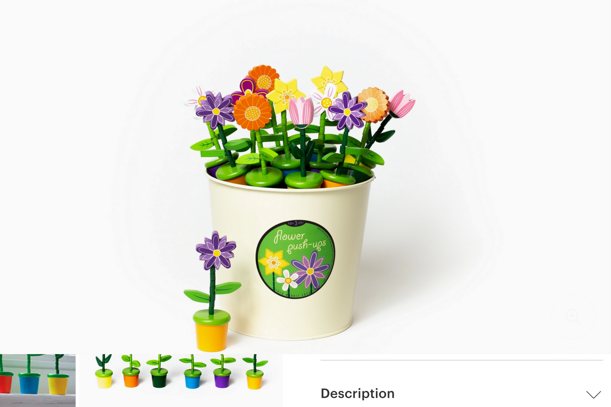 Colorful artificial flowers in a pot with a decorative label on a white background