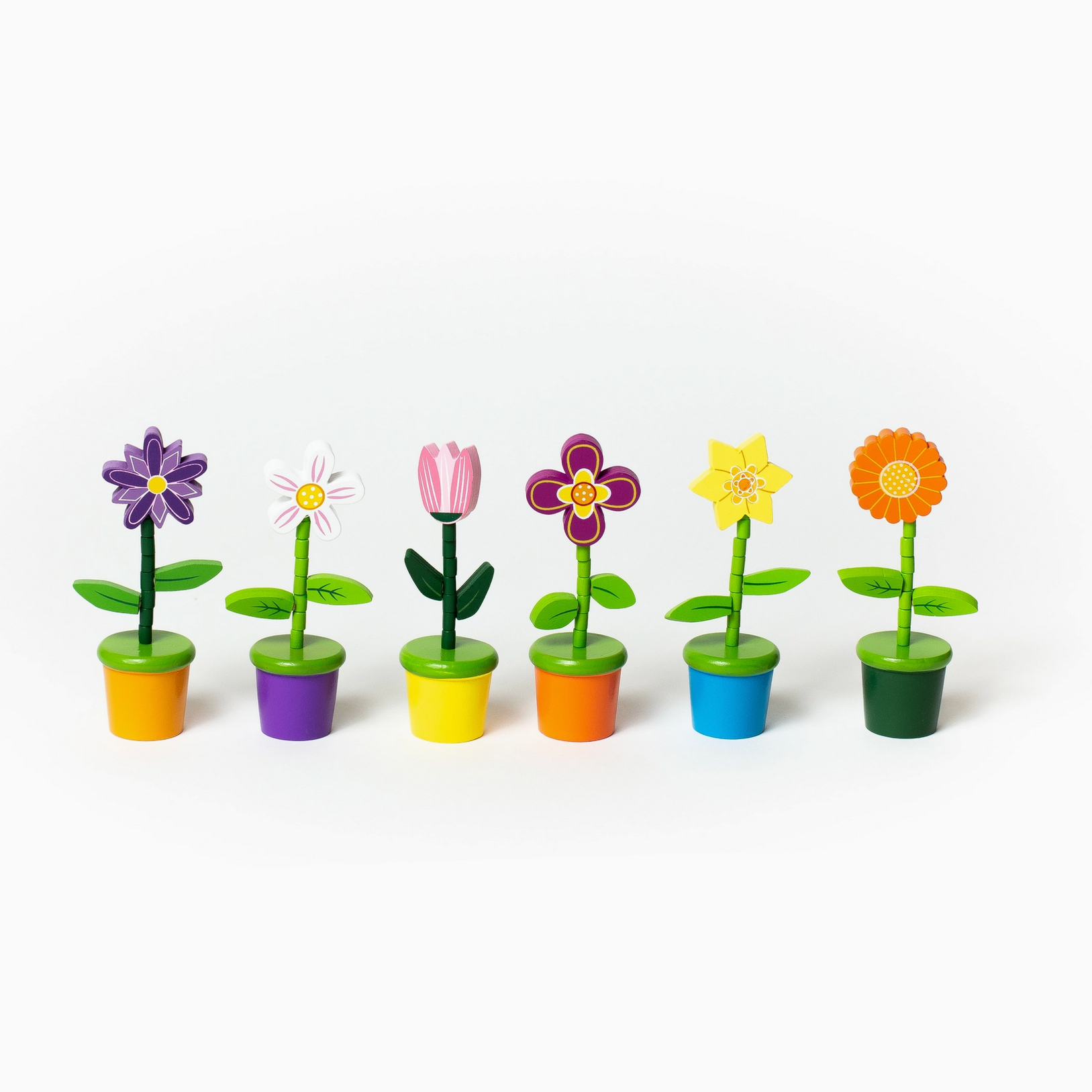 Colorful toy flower pots on a white background