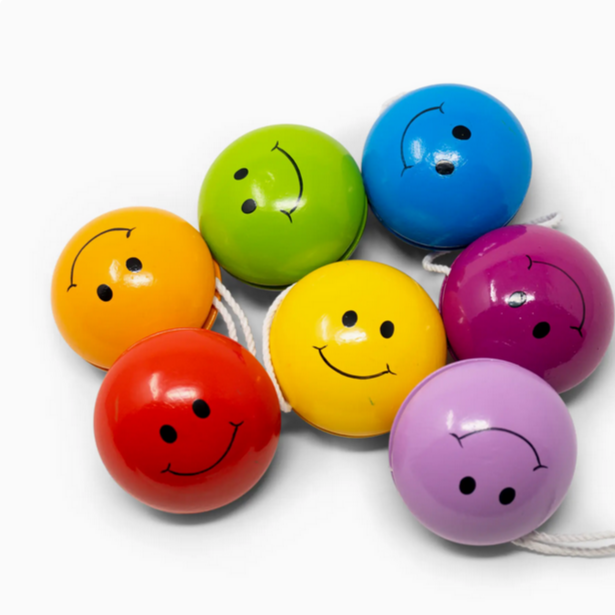 Colorful smiley face yo-yo's on a white background