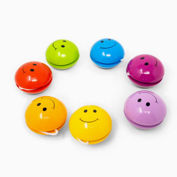 Set of colorful smiley face yo-yo's on a white background
