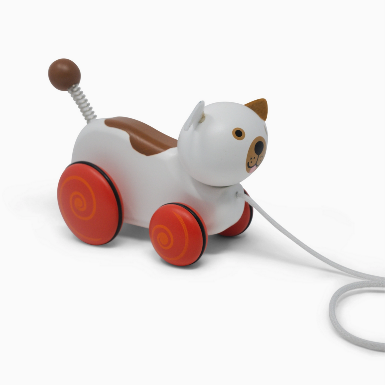 White toy dog with red wheels on a white background