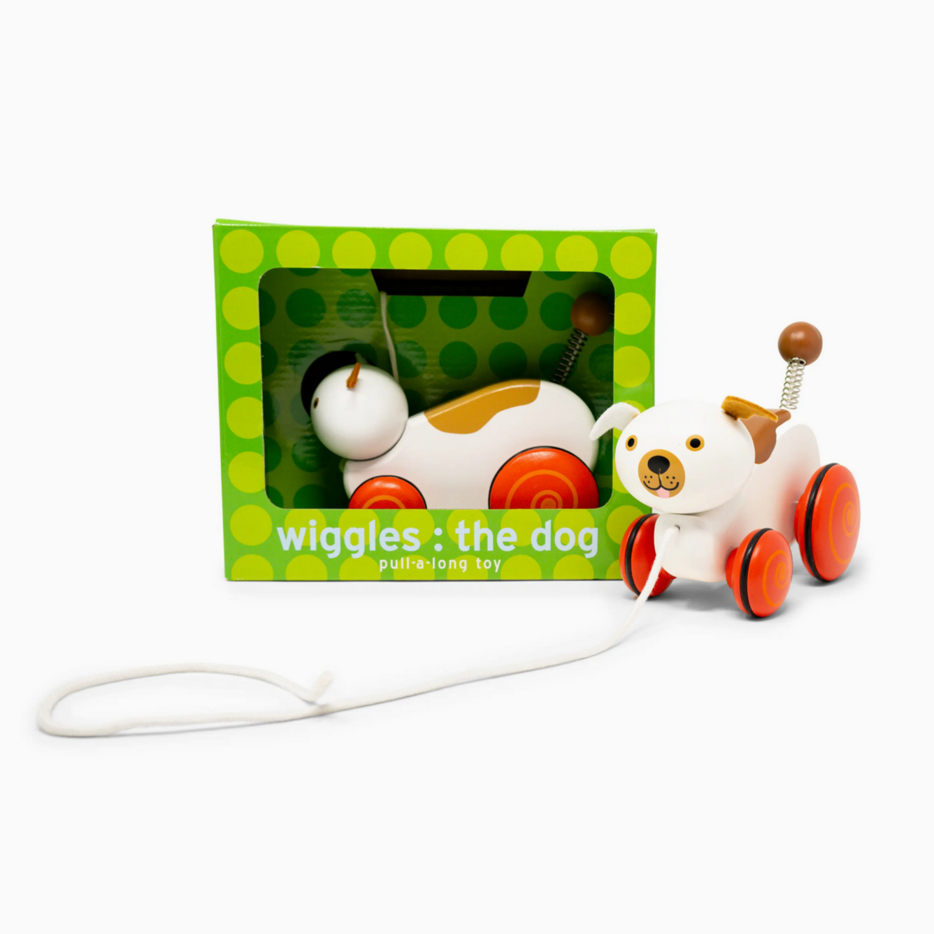 Toy dog on wheels with packaging labeled 'Wiggles the Dog' on a white background