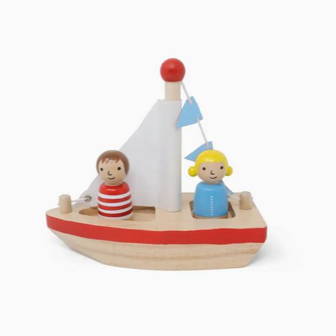 Wooden toy boat with two figures on a white background