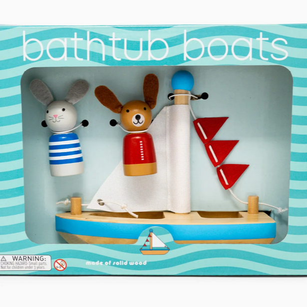 Boxed toy bathtub boats with animal figures on a blue and white striped background