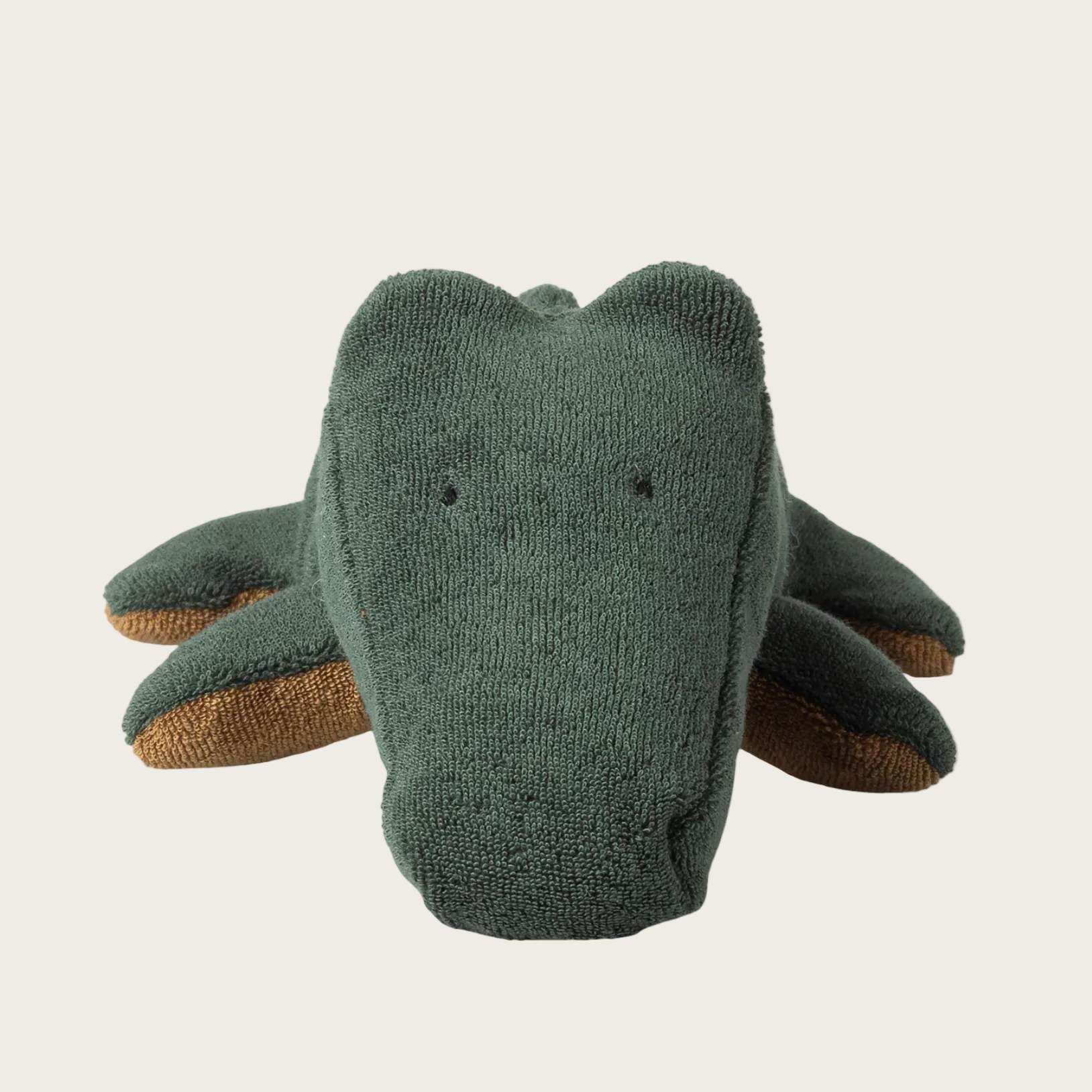 Knitted toy elephant on a beige background