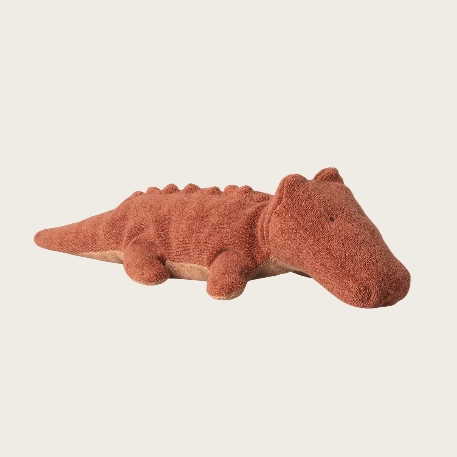 Plush toy alligator on a website page with product details.