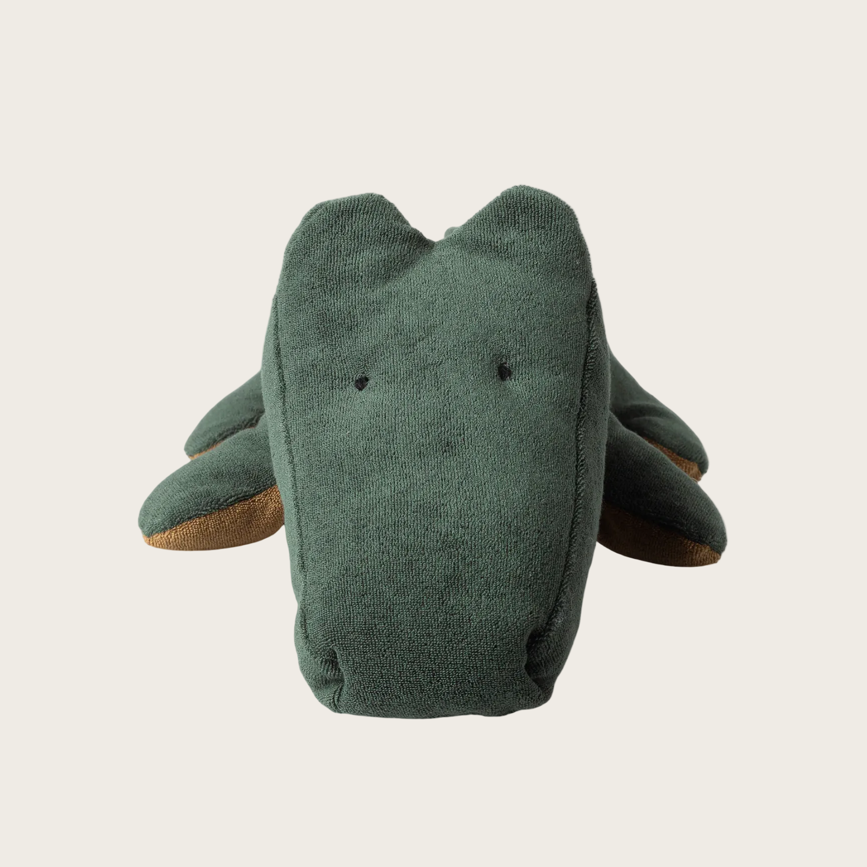 Green plush toy with a neutral background