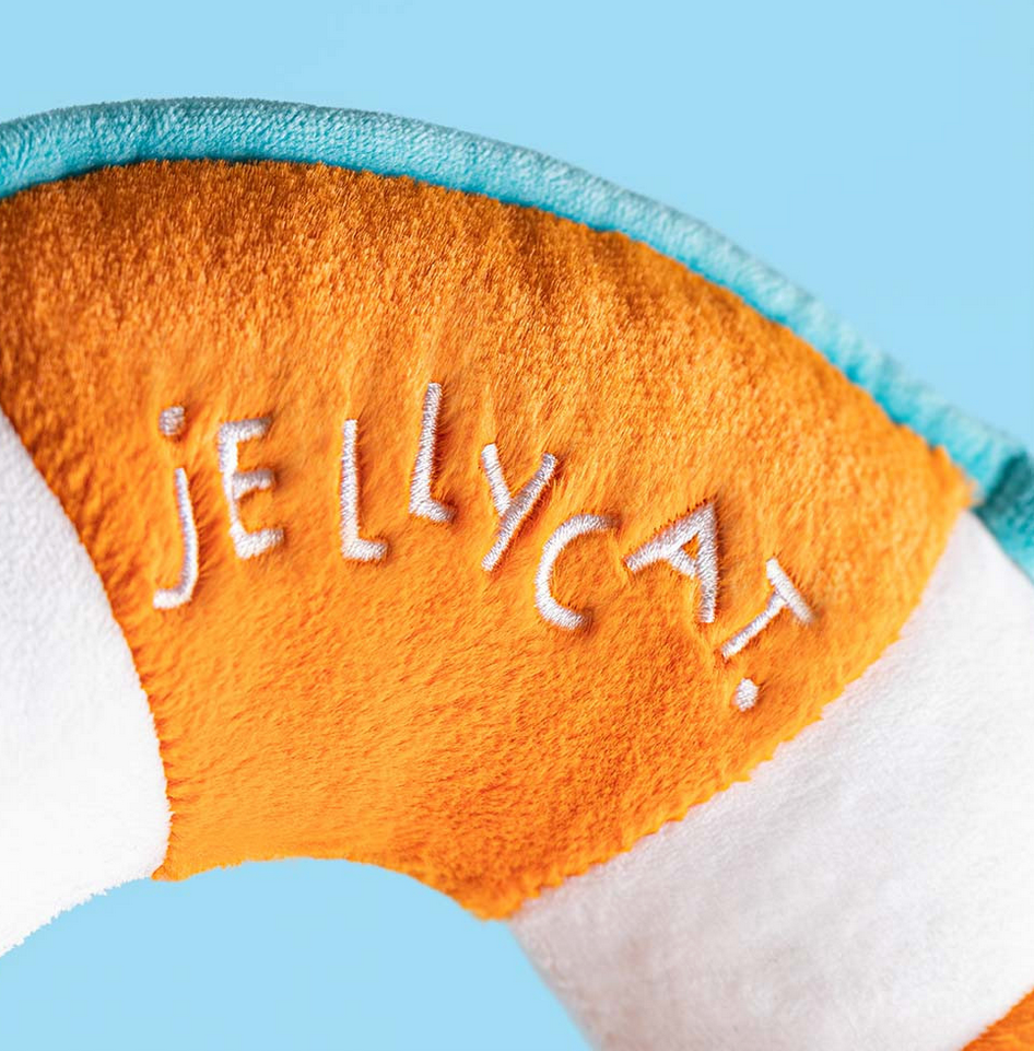 Orange and white plush toy with 'JELLYCAT' branding on a blue background