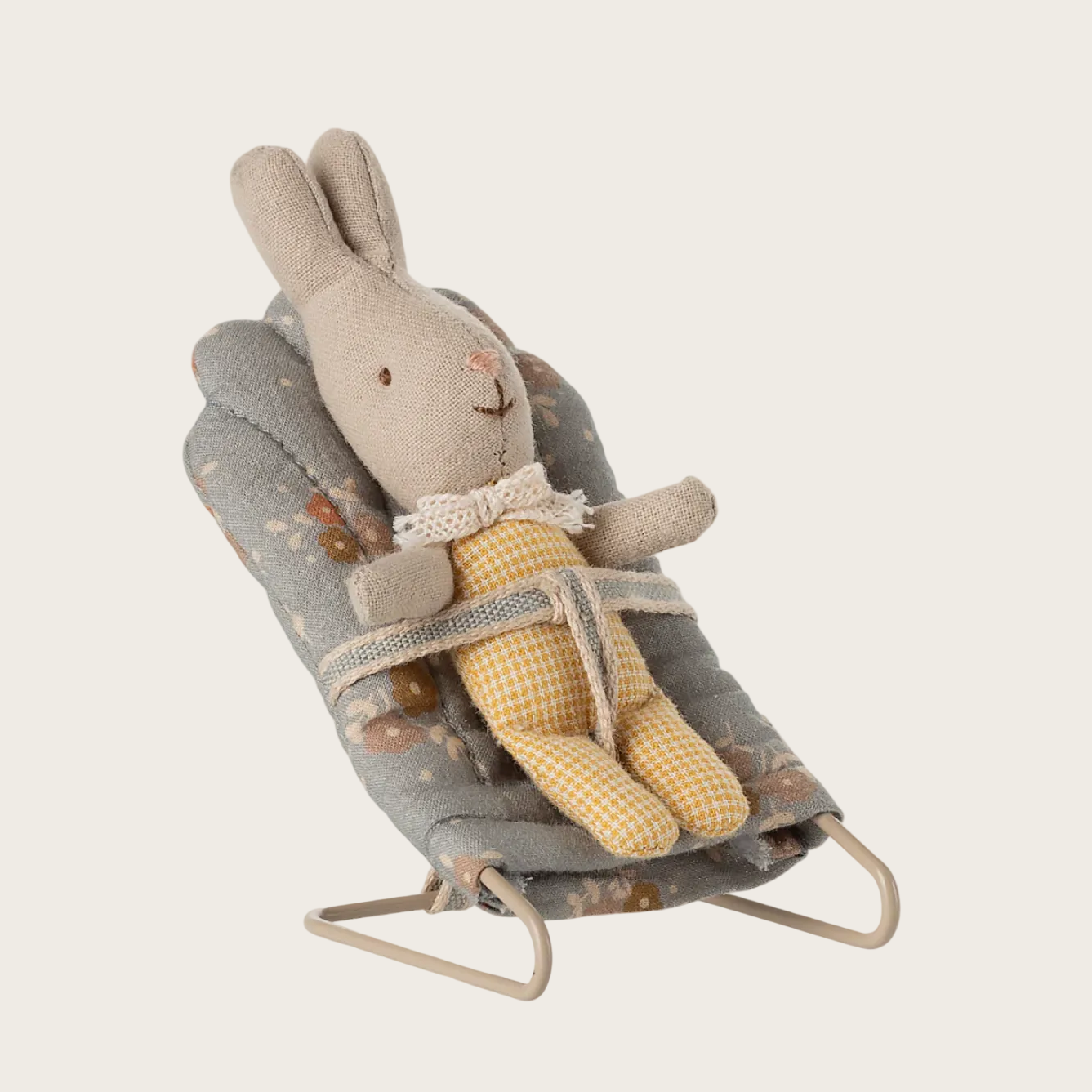 Toy rabbit in a gray cradle on a white background