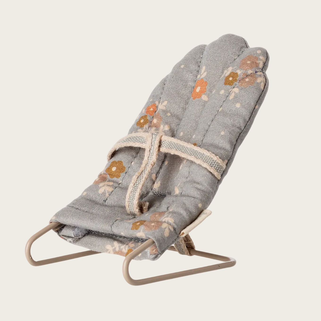 Gray baby bouncer with floral patterns on a white background