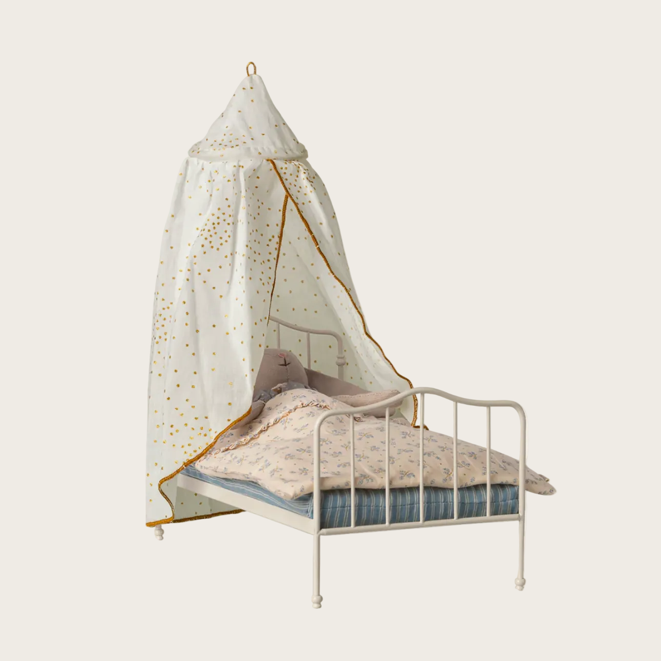 Bed with canopy and bedding on a light background