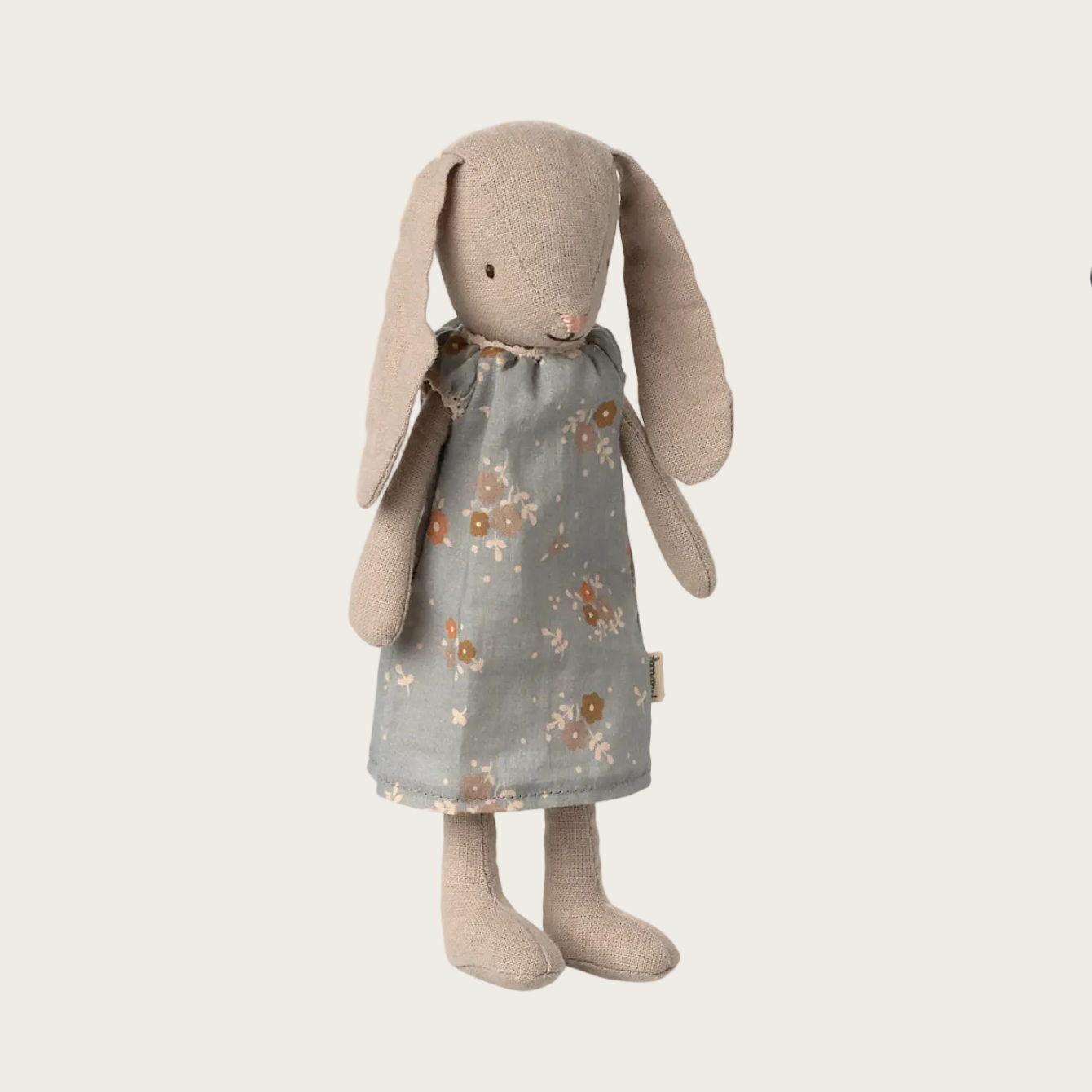 Stuffed bunny toy with a floral dress on a website page