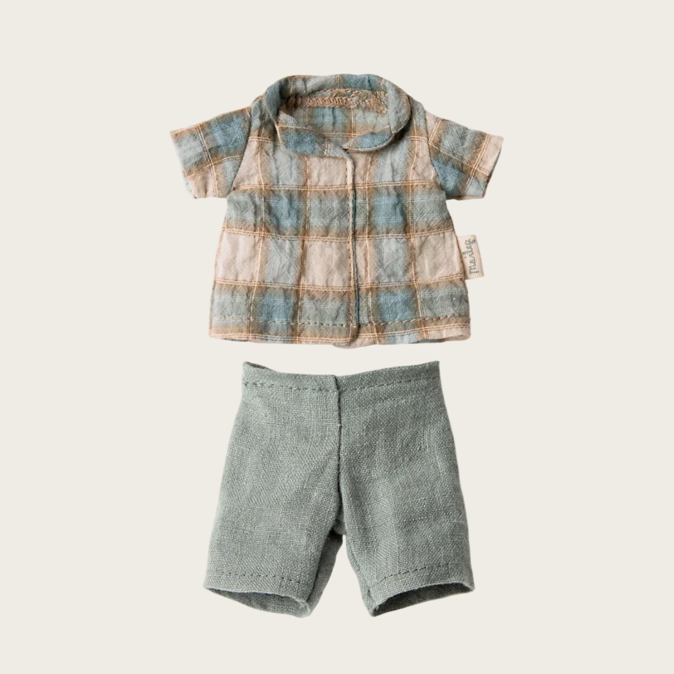 Plaid shirt and gray shorts on a website page with product options.