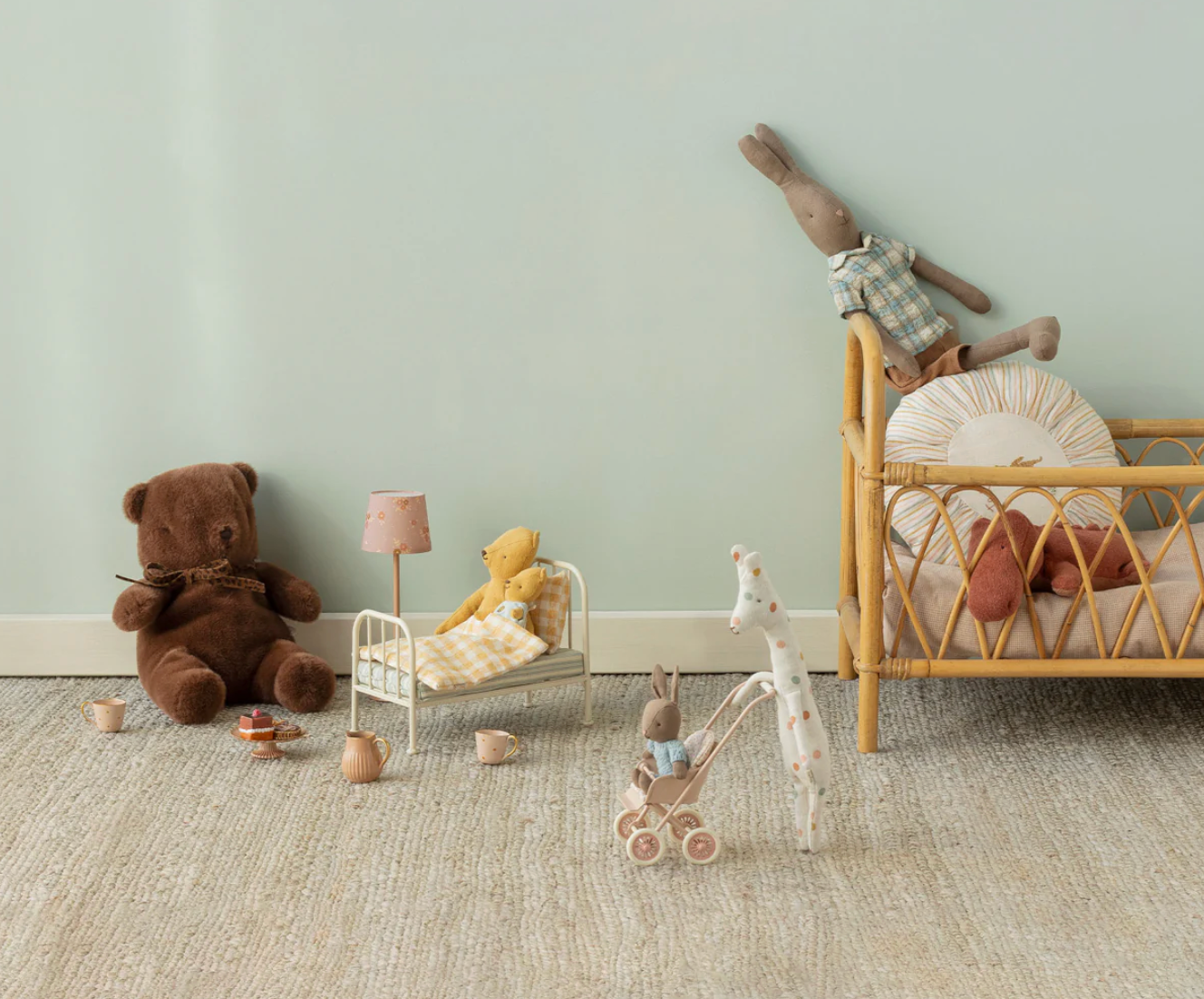 Children's toys and furniture in a room with a light green wall.