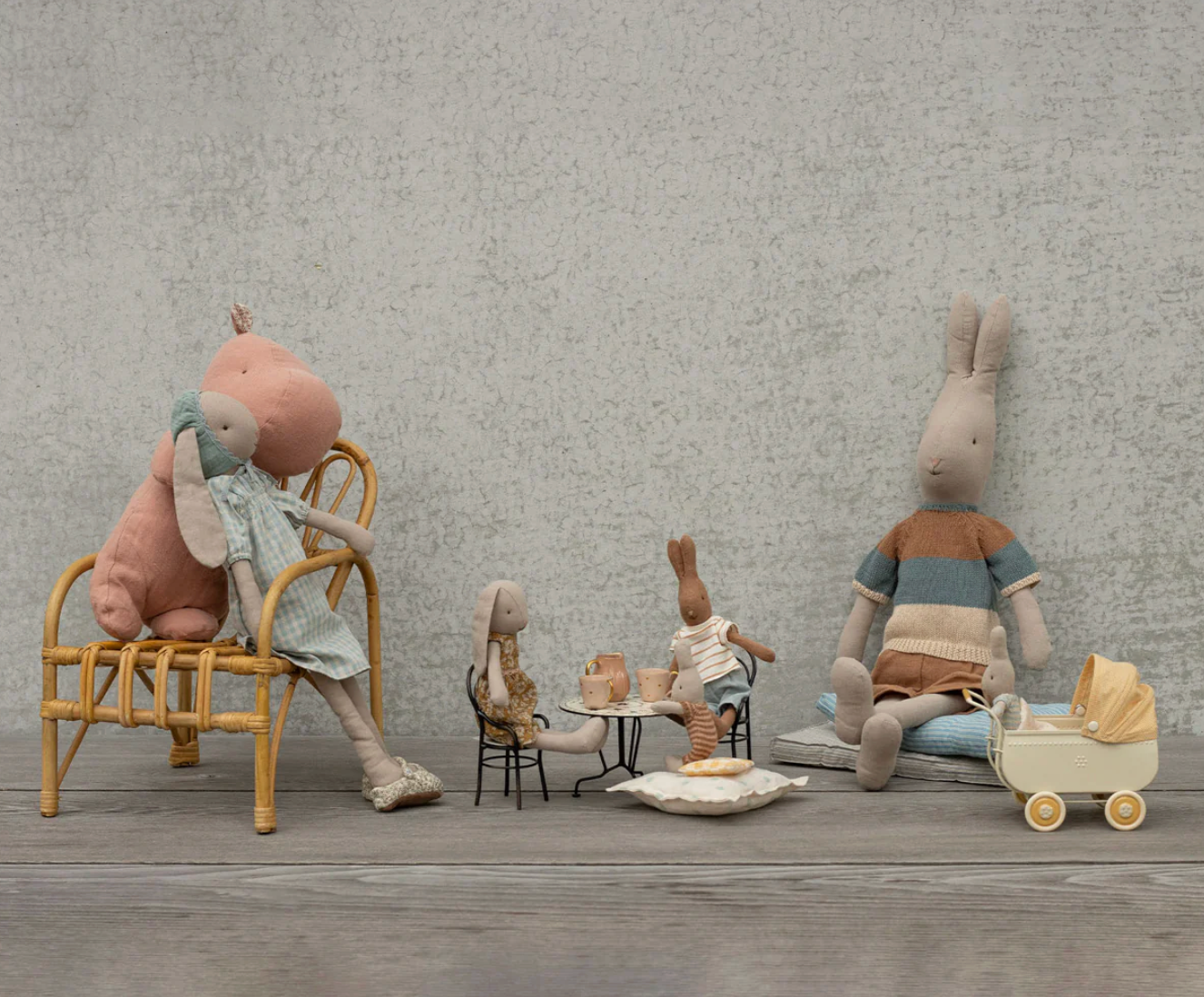 Set of stylized stuffed animals in a staged indoor setting with furniture and props.