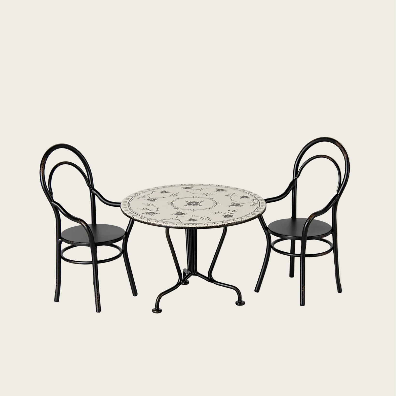 Round table with floral design and two chairs 