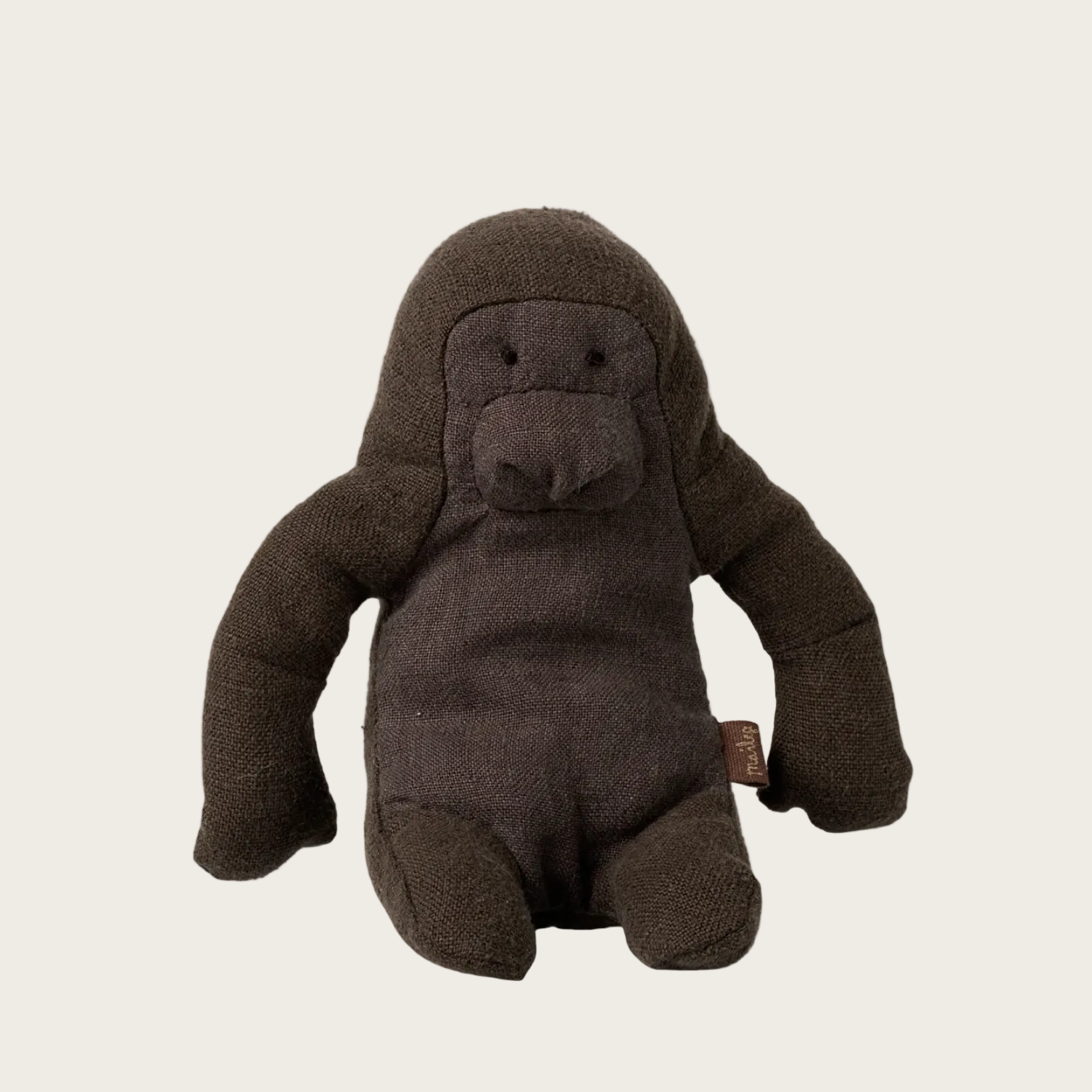 Stuffed toy gorilla on a beige background