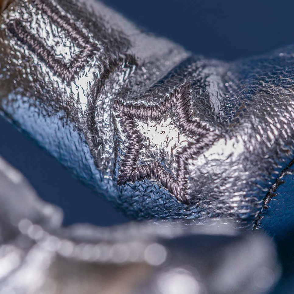 Close-up of a textured metallic object with 'Amusables Peanut Space Radar Outfit' text.