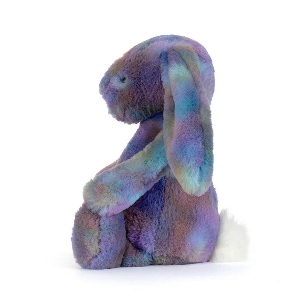 Stuffed bunny toy with a tie-dye pattern on a white background