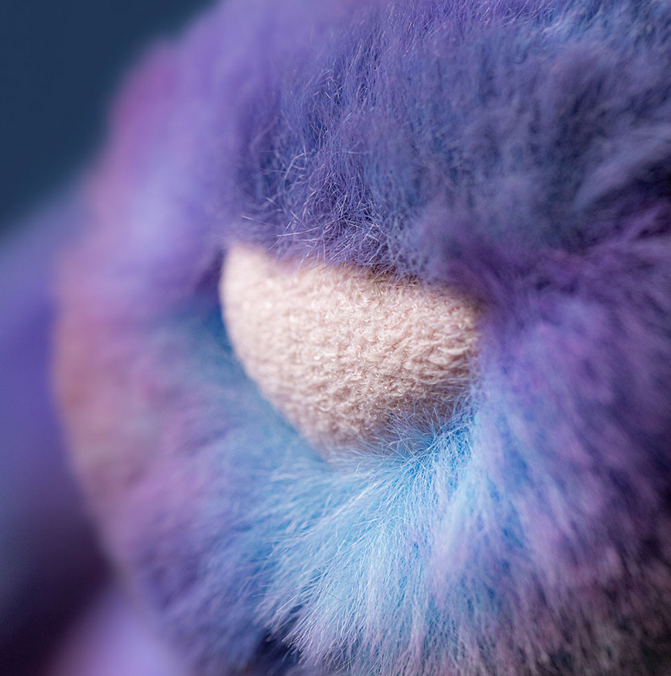 Close-up of a fluffy purple and blue object with a textured surface.