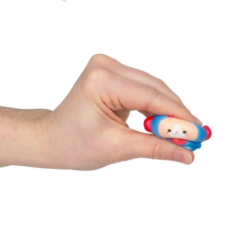 Hand holding a small blue and red figurine 