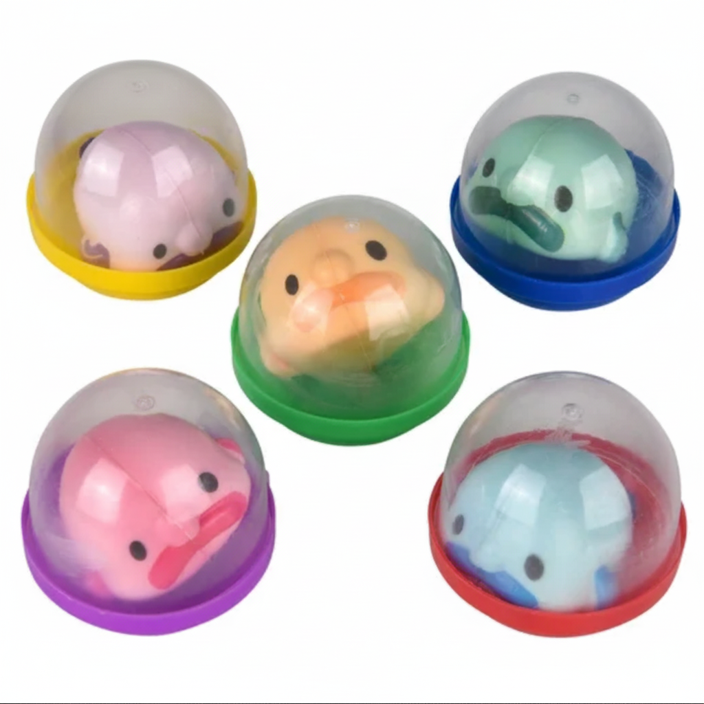 Set of colorful duck-shaped rubber stamps in transparent domes on a white background.