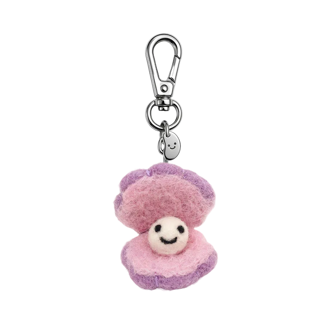 Plush keychain with a smiling face on a white background