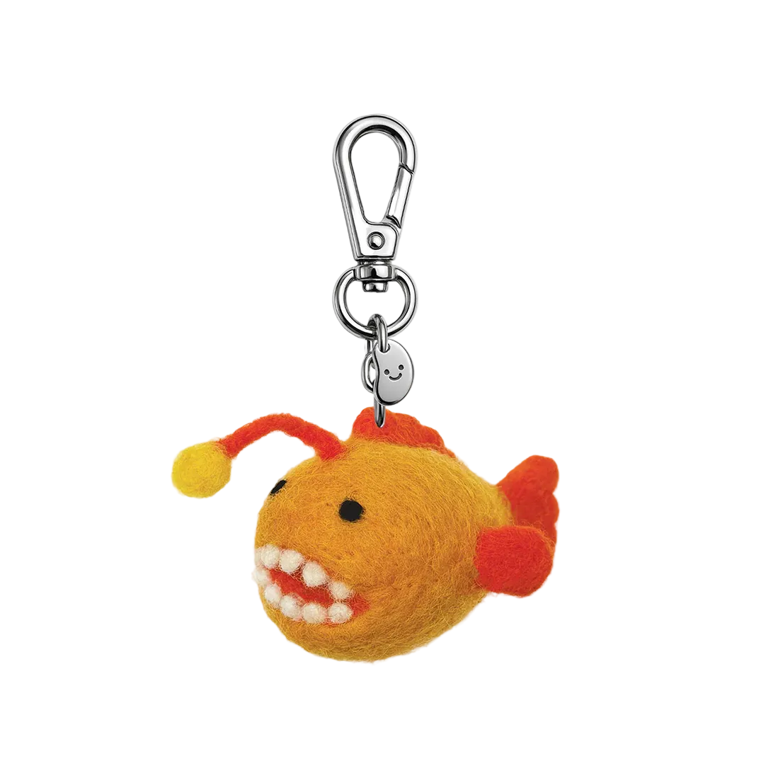 Fuzzy fish-shaped keychain with a carabiner on a white background