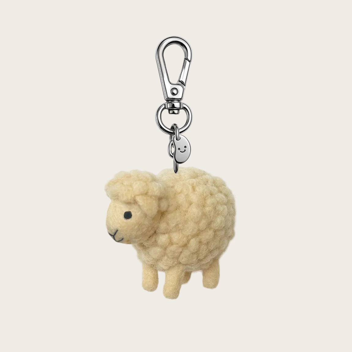 Sheep-shaped keychain with a metal clip on a white background