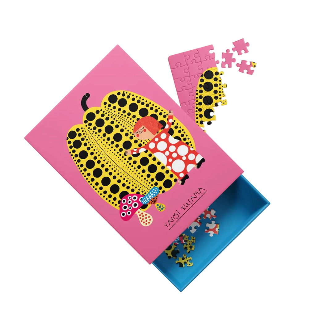 Colorful puzzle set with a pink box featuring a design of a child and a pumpkin on a white background.