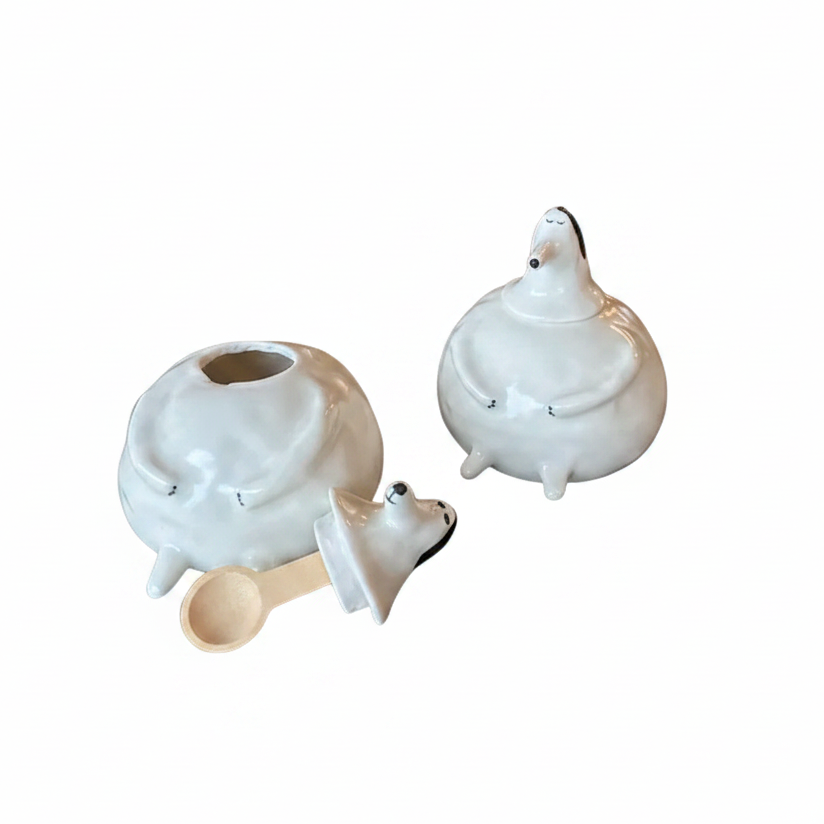 Set of three white ceramic animal-shaped items on a white background