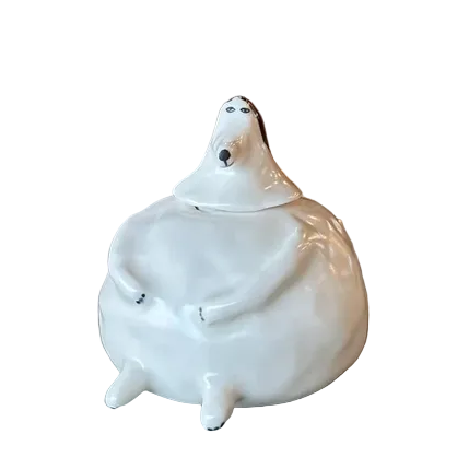 White ceramic figure of a dog on a white background
