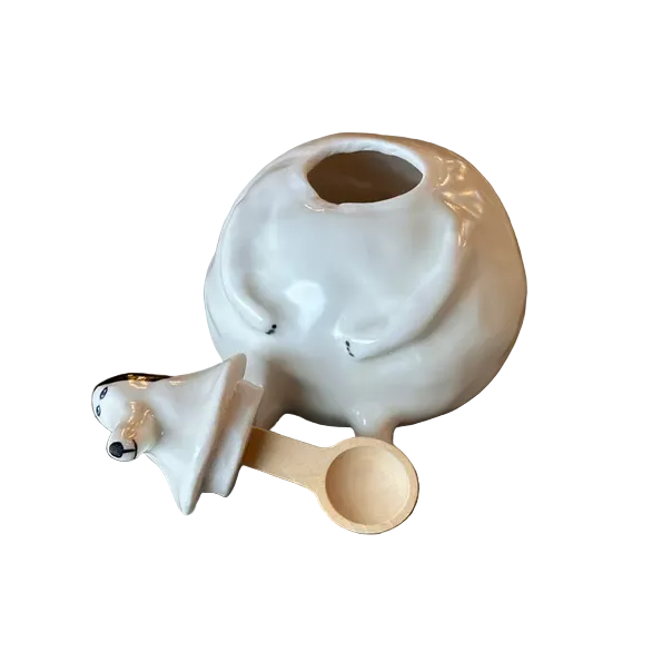 White ceramic container with a wooden spoon 