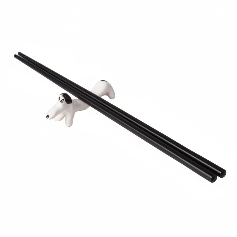 Gold and white dog-shaped chopstick rest on a light gray background