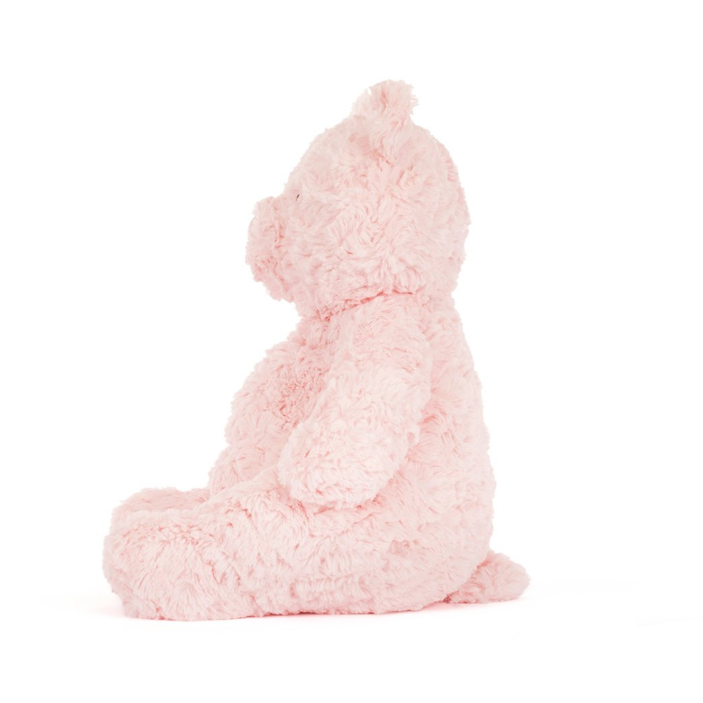 Pink plush bear toy on a white background 