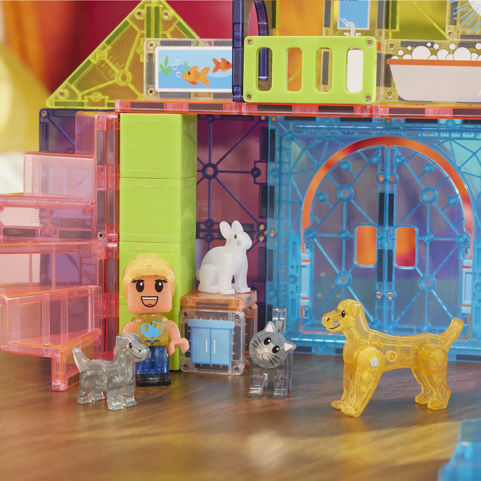 Toy building set with transparent blocks and small figures on a wooden surface