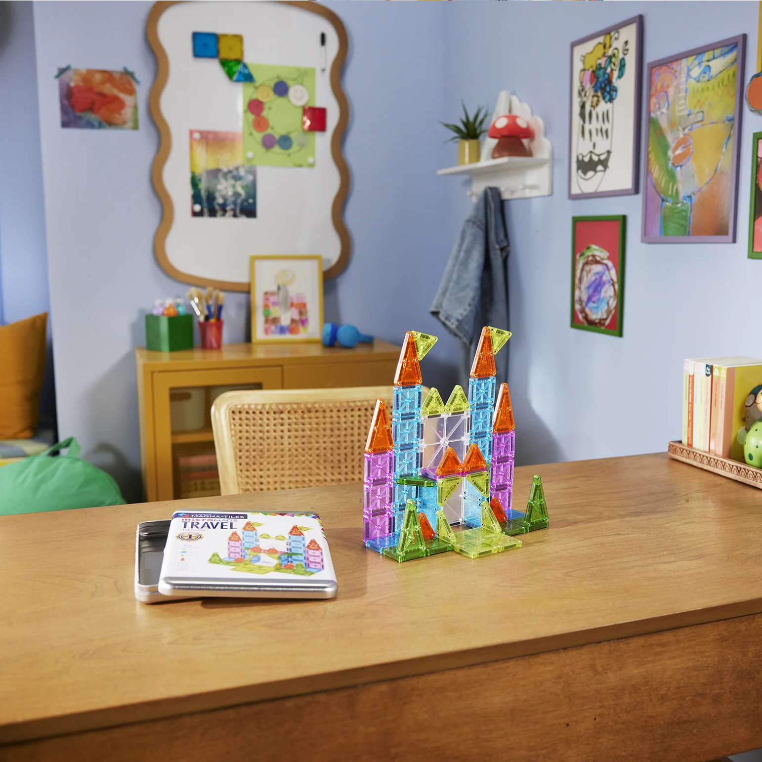 Children's room with a desk, colorful toys, and wall decorations.