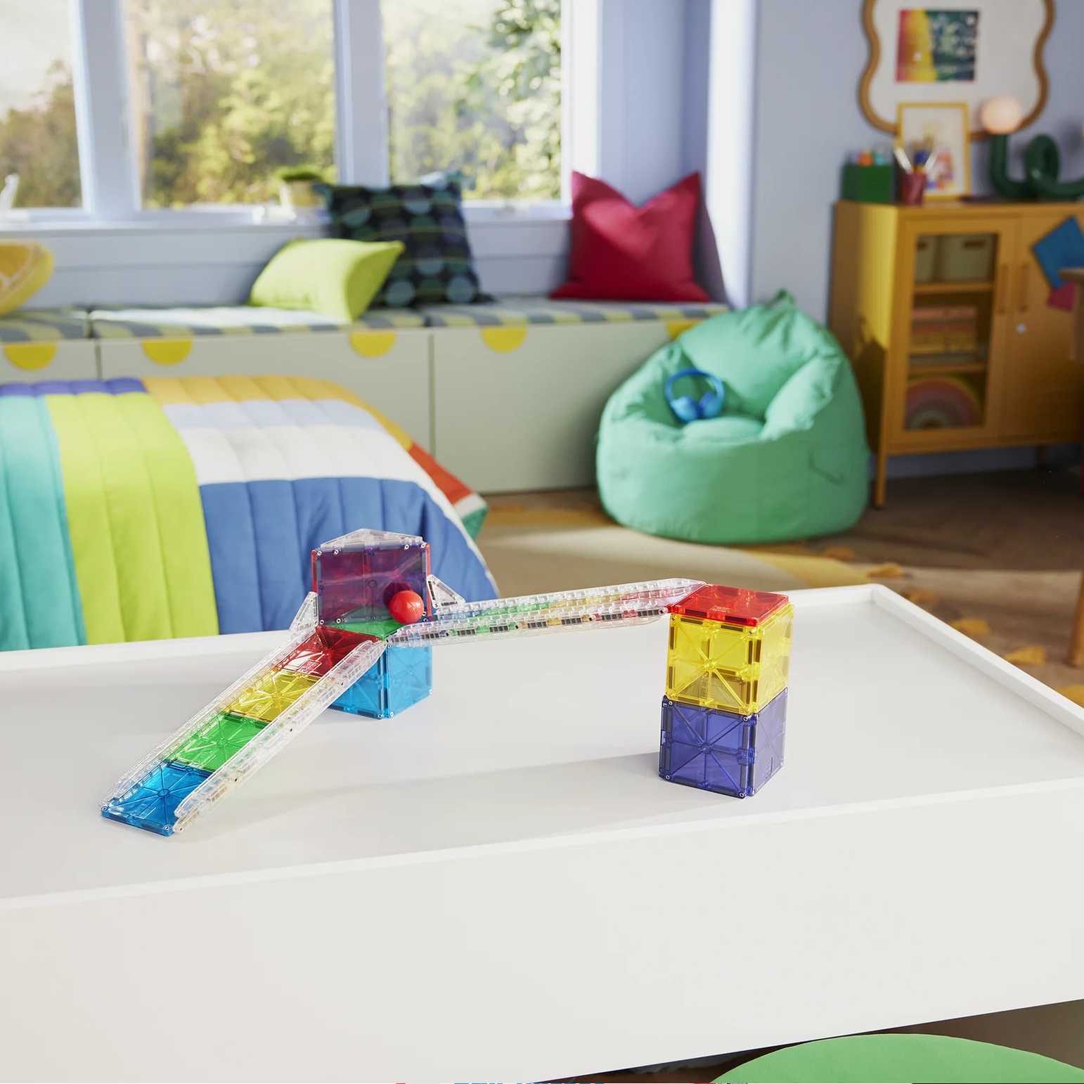 Children's room with a white activity table, colorful blocks, and a bean bag chair.