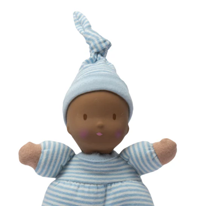 Baby doll with blue and white striped outfit and hat on a white background