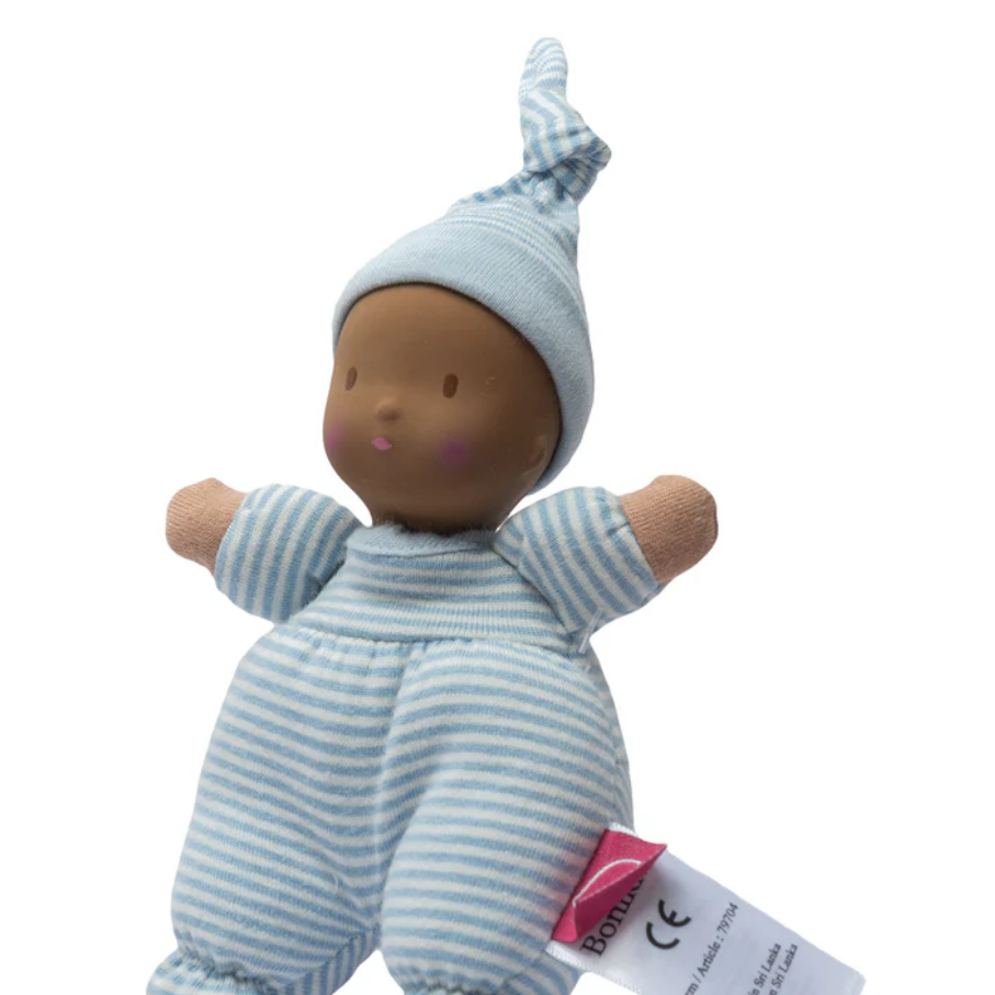 Plush baby doll with blue striped outfit and hat on a white background