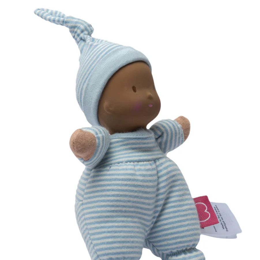 Baby doll with blue striped outfit and hat on a white background