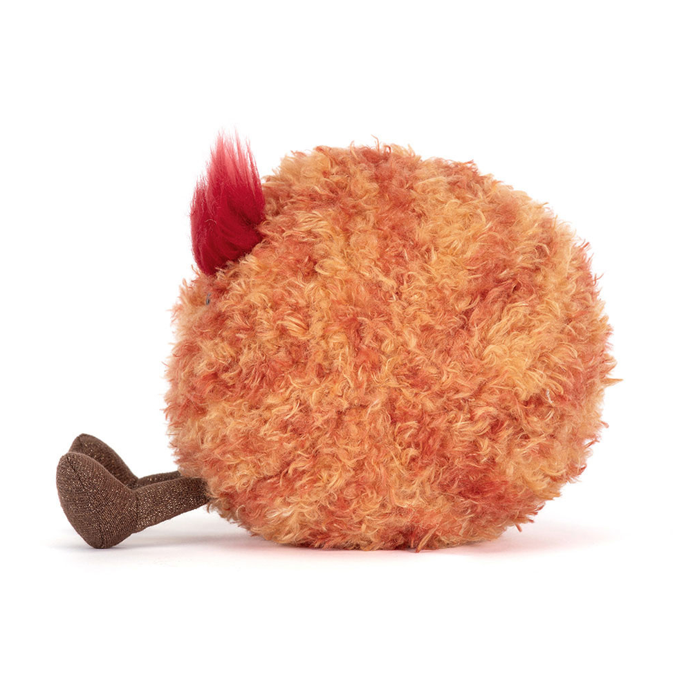 Plush toy resembling a planet Mars with a red top on a white background