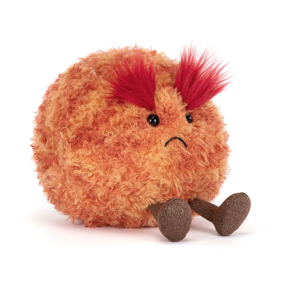 Plush toy resembling a planet with red hair on a white background
